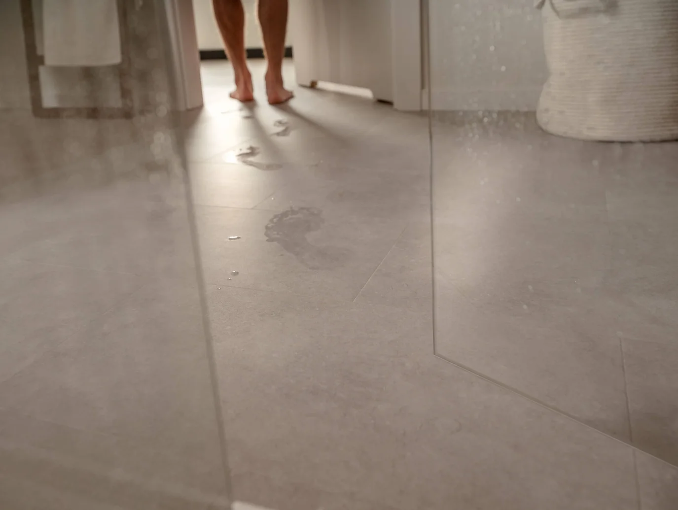 Mokre ślady stóp na podłodze łazienki